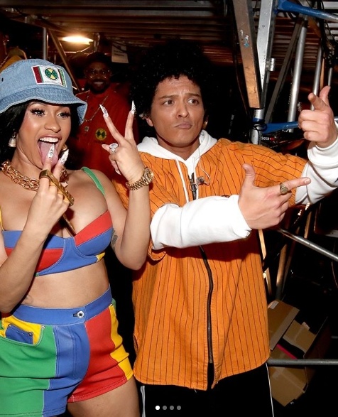 Bruno Mars and Cardi B pose backstage after performing their song Finesse at the Grammys